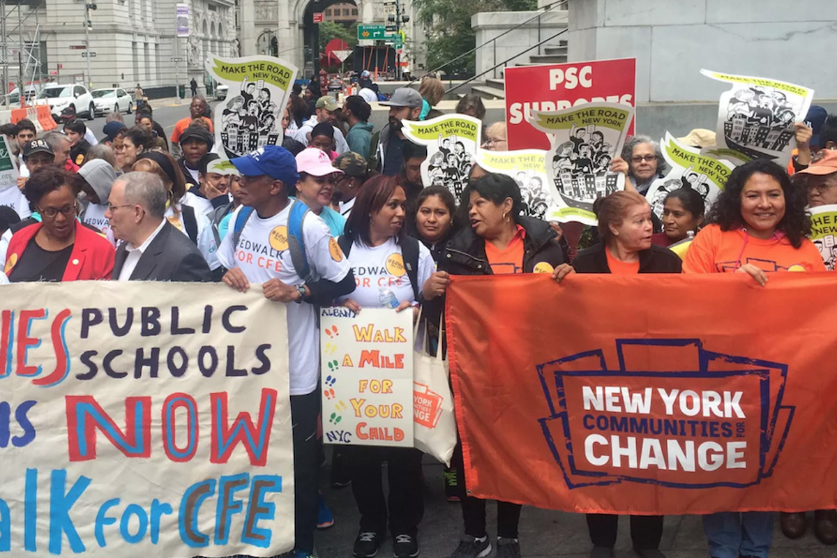 People marching down the street advocating for education equity